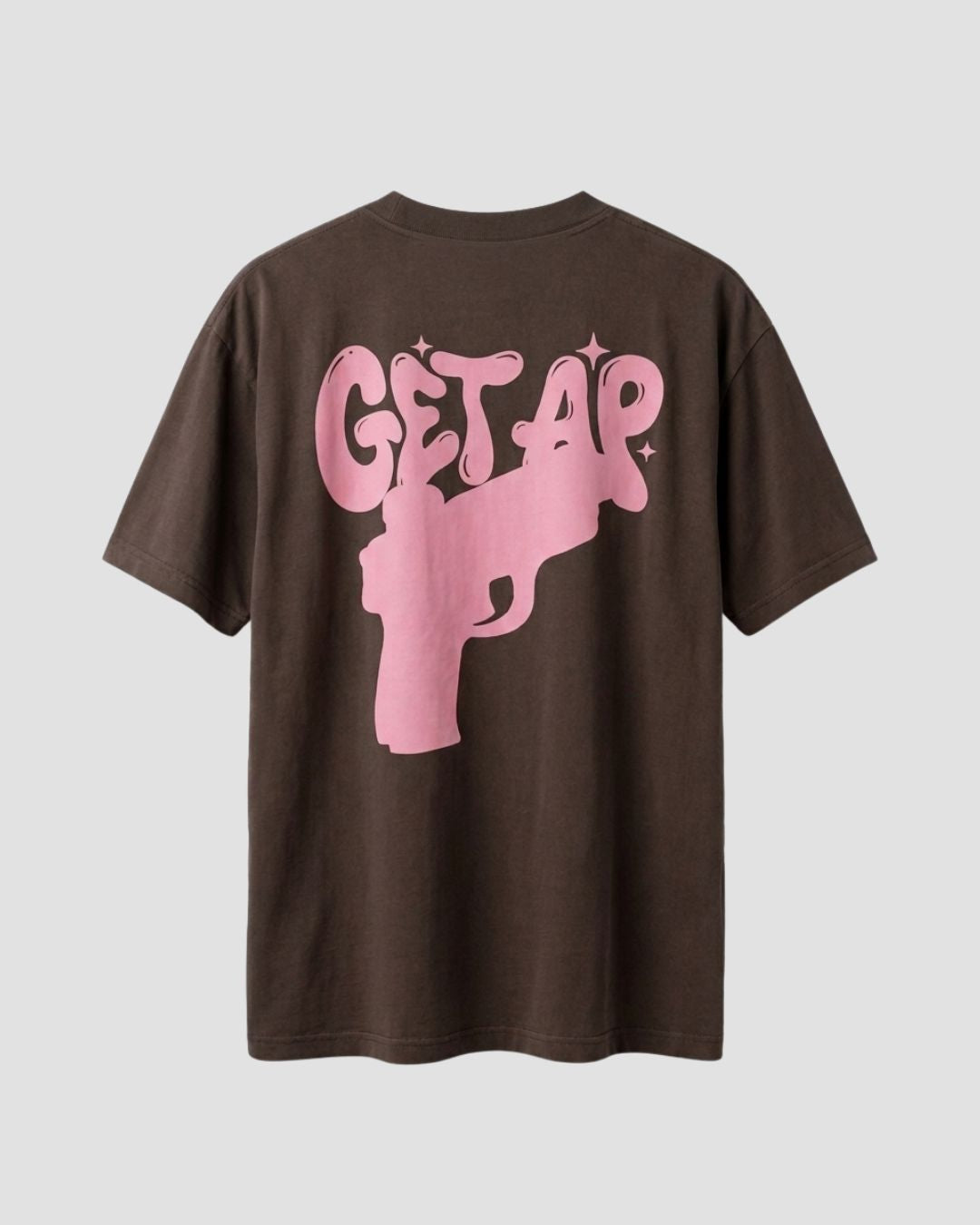 Brown t-shirt with pink graphic and text on a light gray background