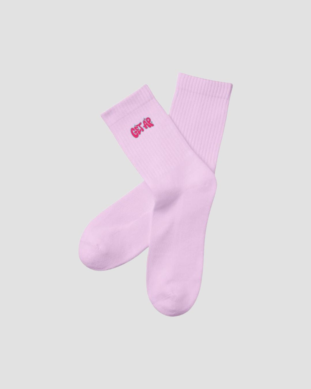Pair of pink socks with a logo on a light gray background